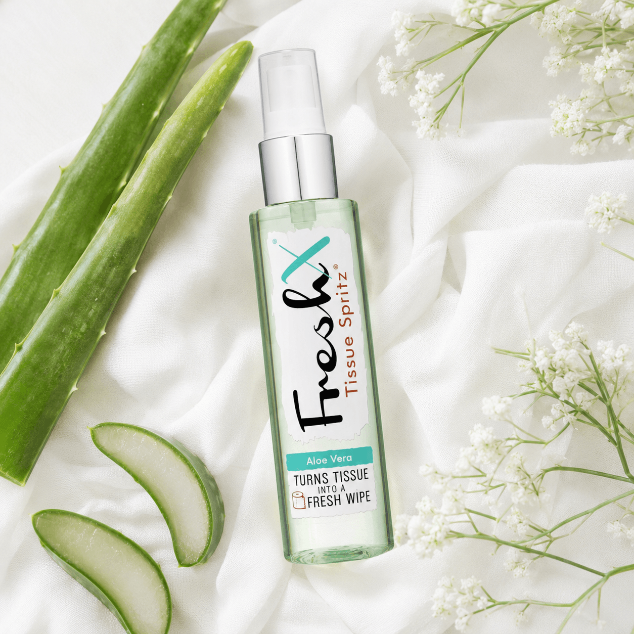 FreshX Tissue Spritz bottle with aloe vera leaves and flowers on a light background