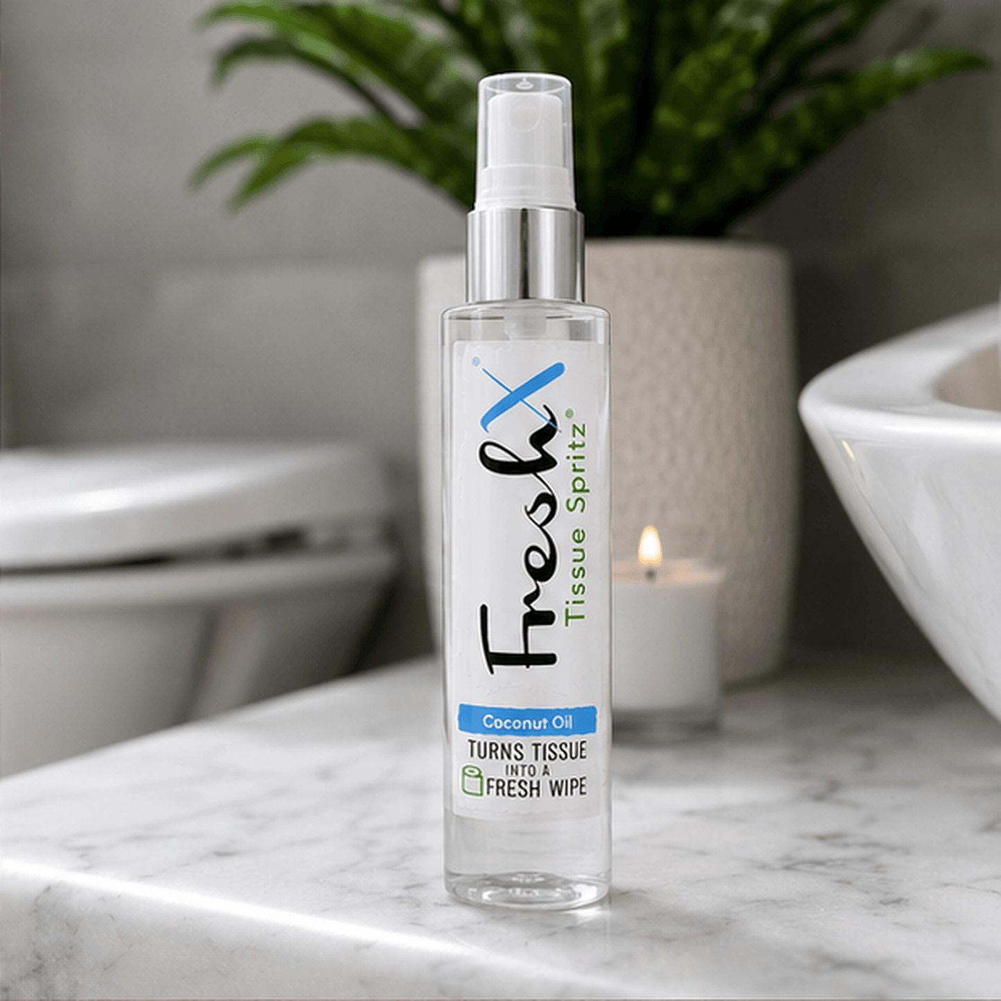 FreshX Tissue Spritz bottle on a marble surface with a blurred bathroom background