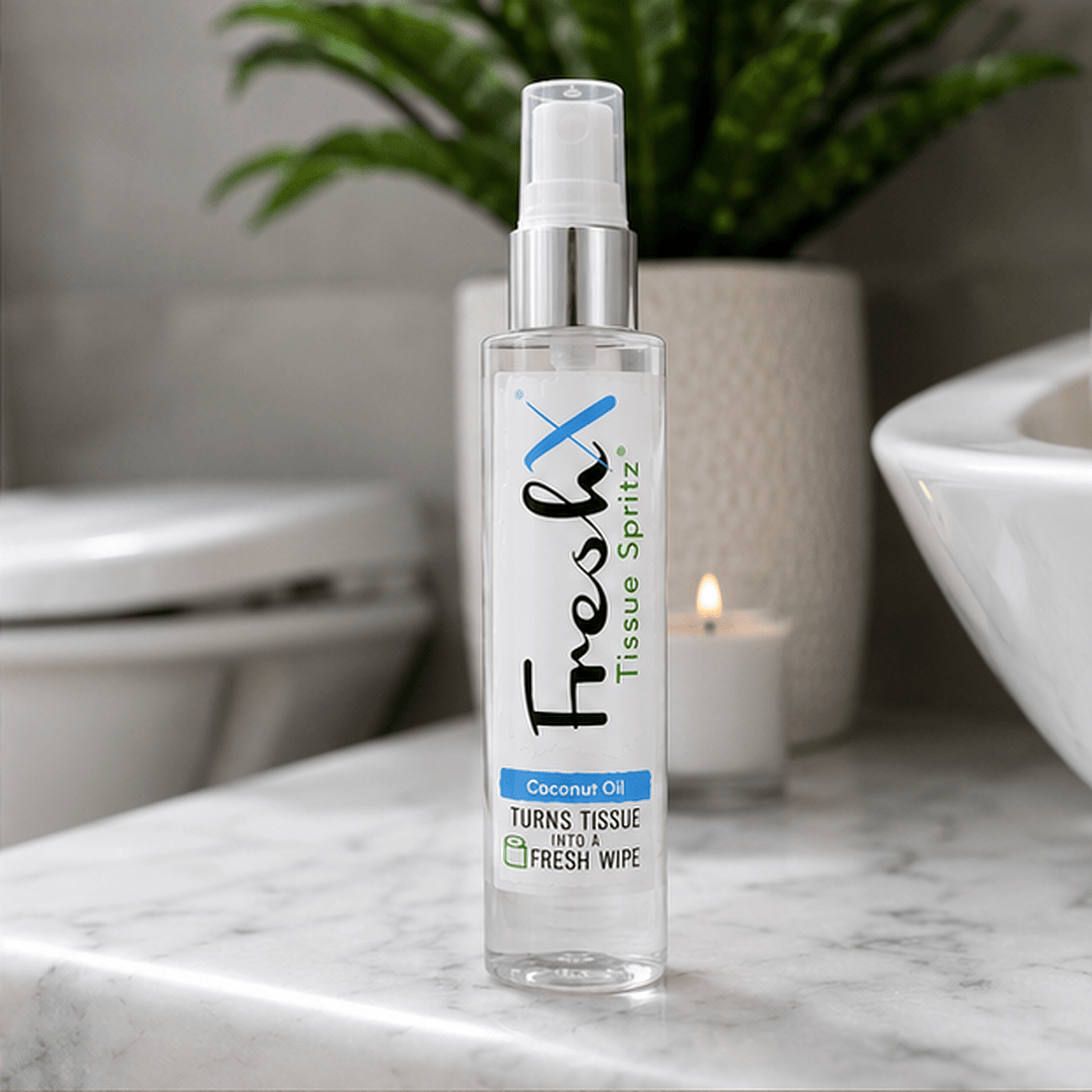 FreshX Tissue Spritz bottle on a marble surface with a blurred bathroom background